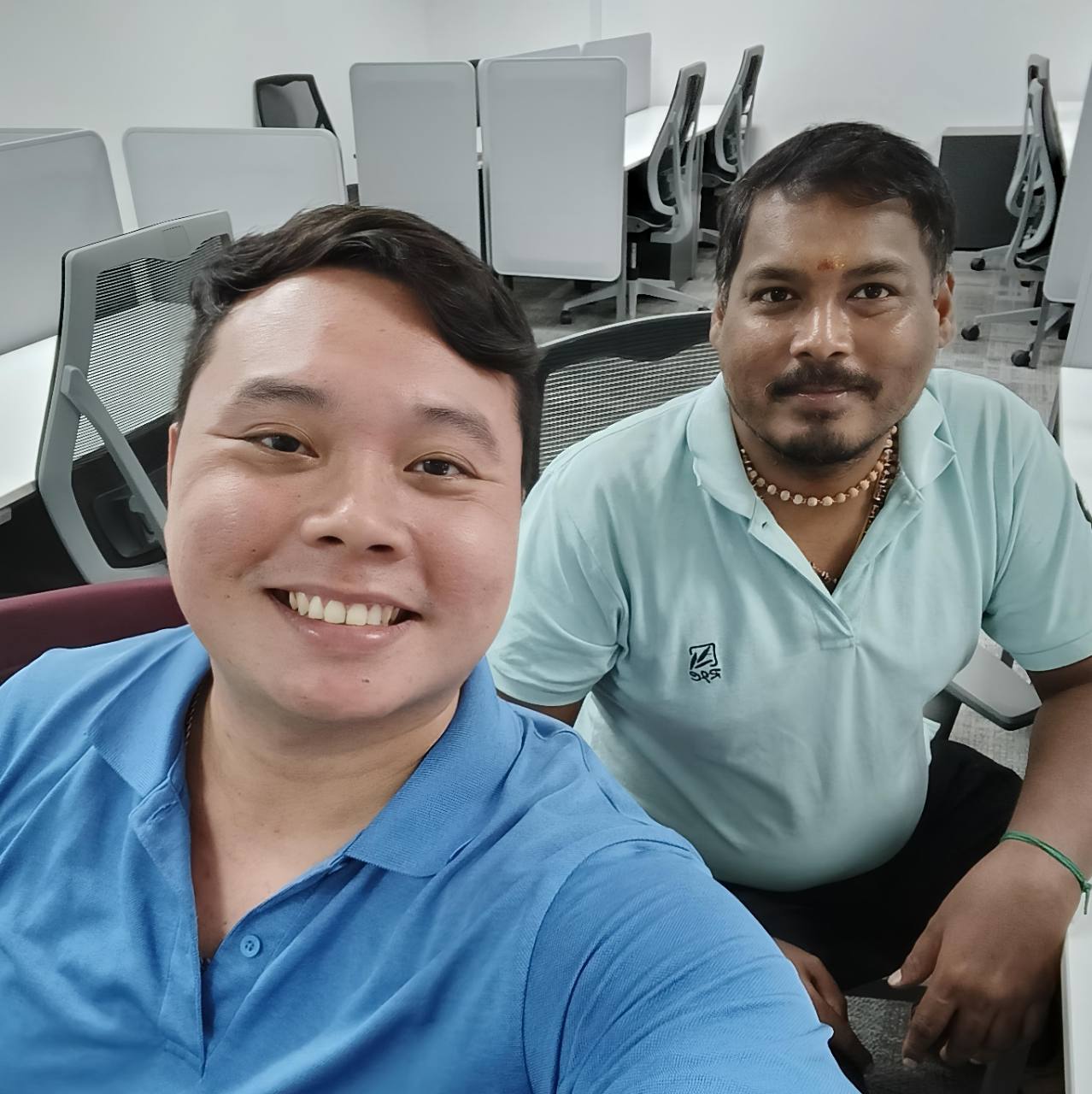 Alvin smiling with a client during an in-person office meeting.